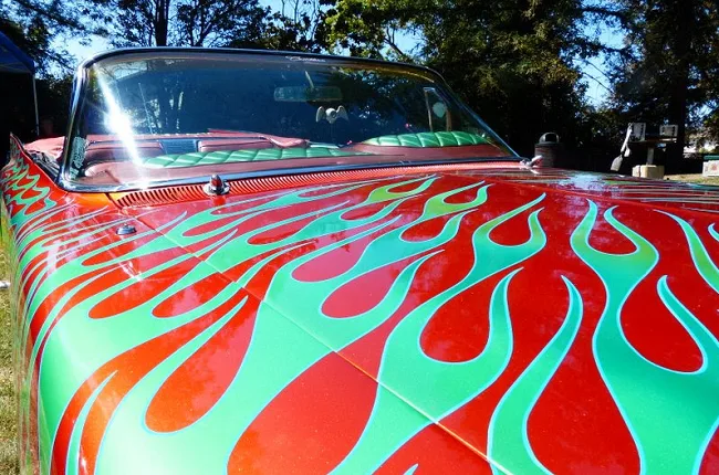 Green flames painted on the red hood of a custom Cadillac