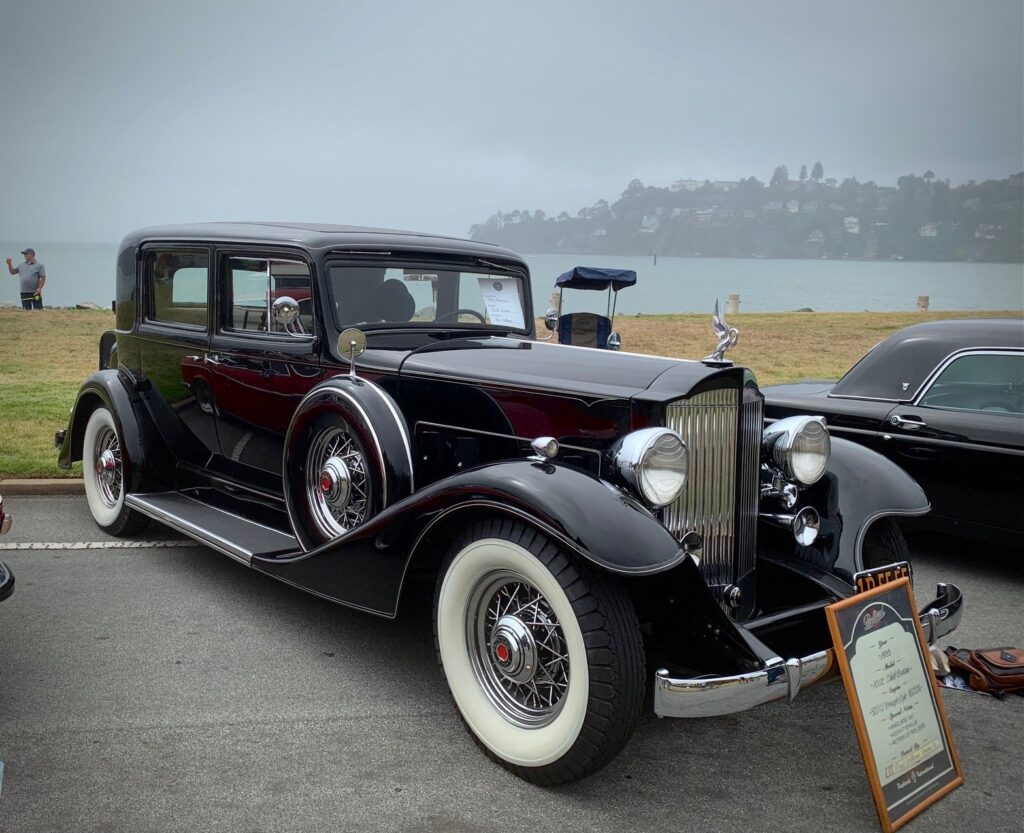 A handsome Packard sedan awaits delivery of occupants in its cosseted interior
